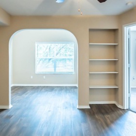 a room with a wood floor and a ceiling fan