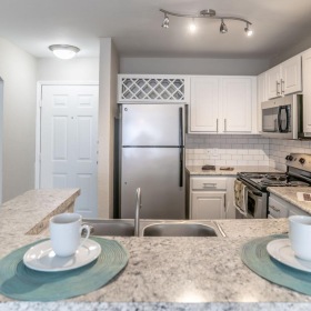 a kitchen with white cabinets