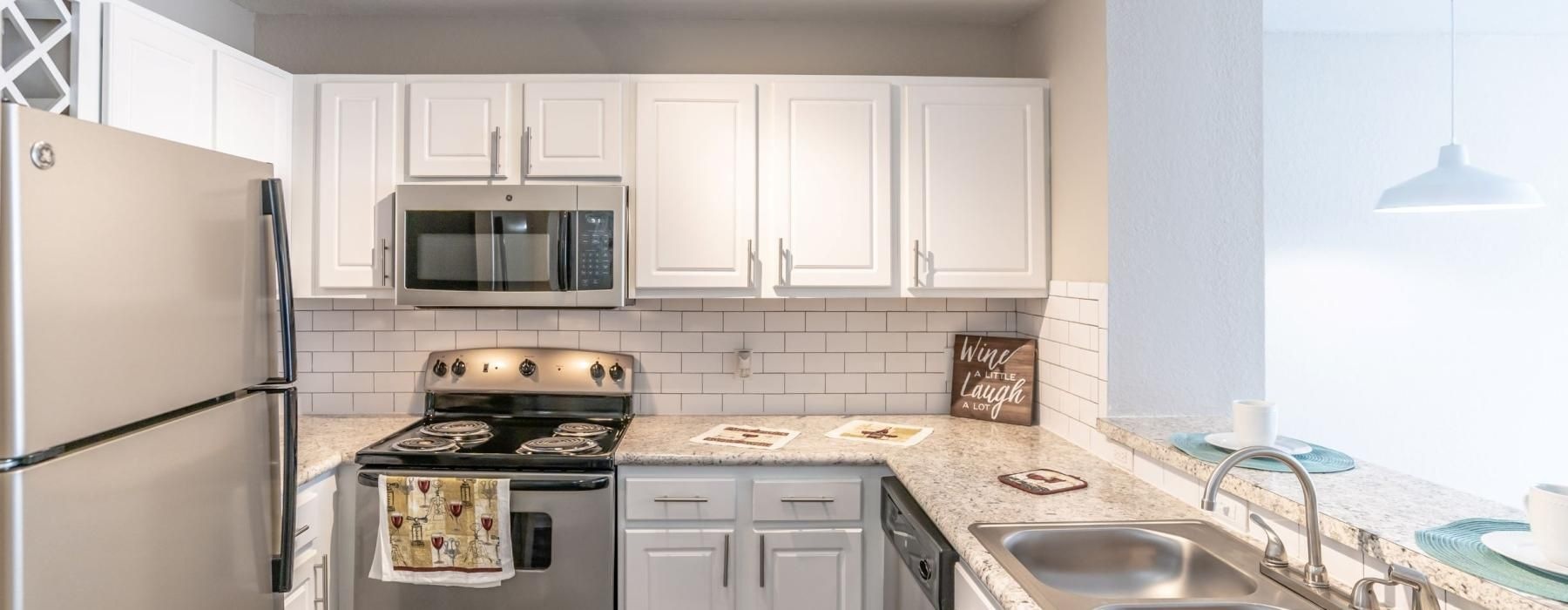 a kitchen with white cabinets