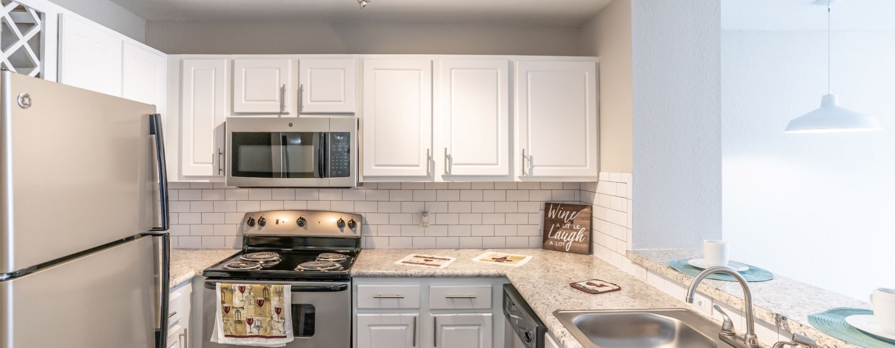 a kitchen with white cabinets