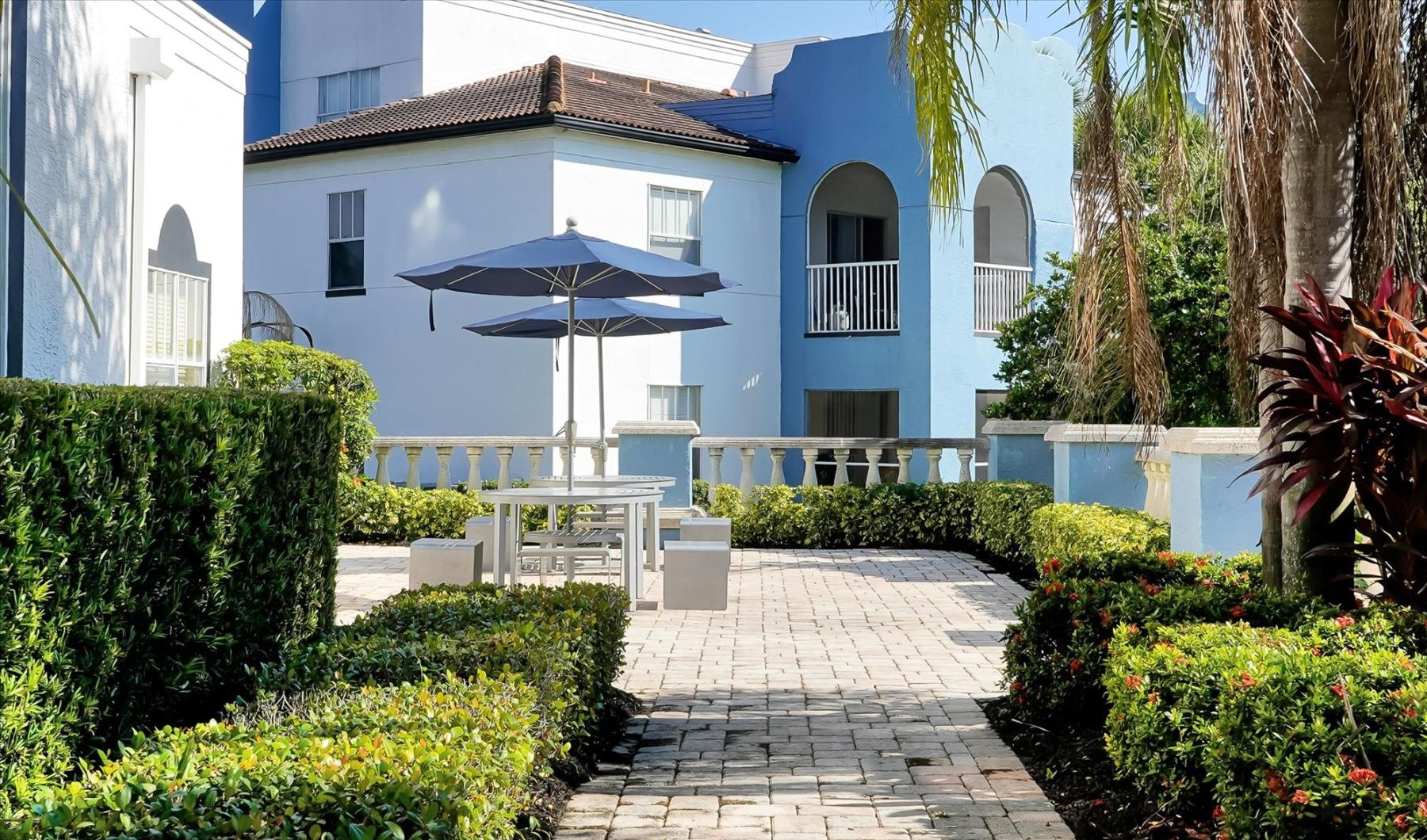 a house with a patio and a brick walkway