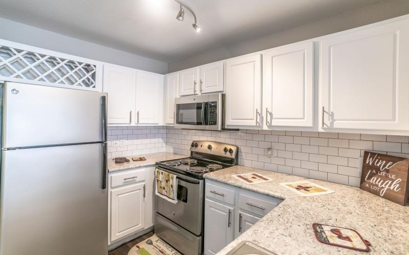 a kitchen with white cabinets